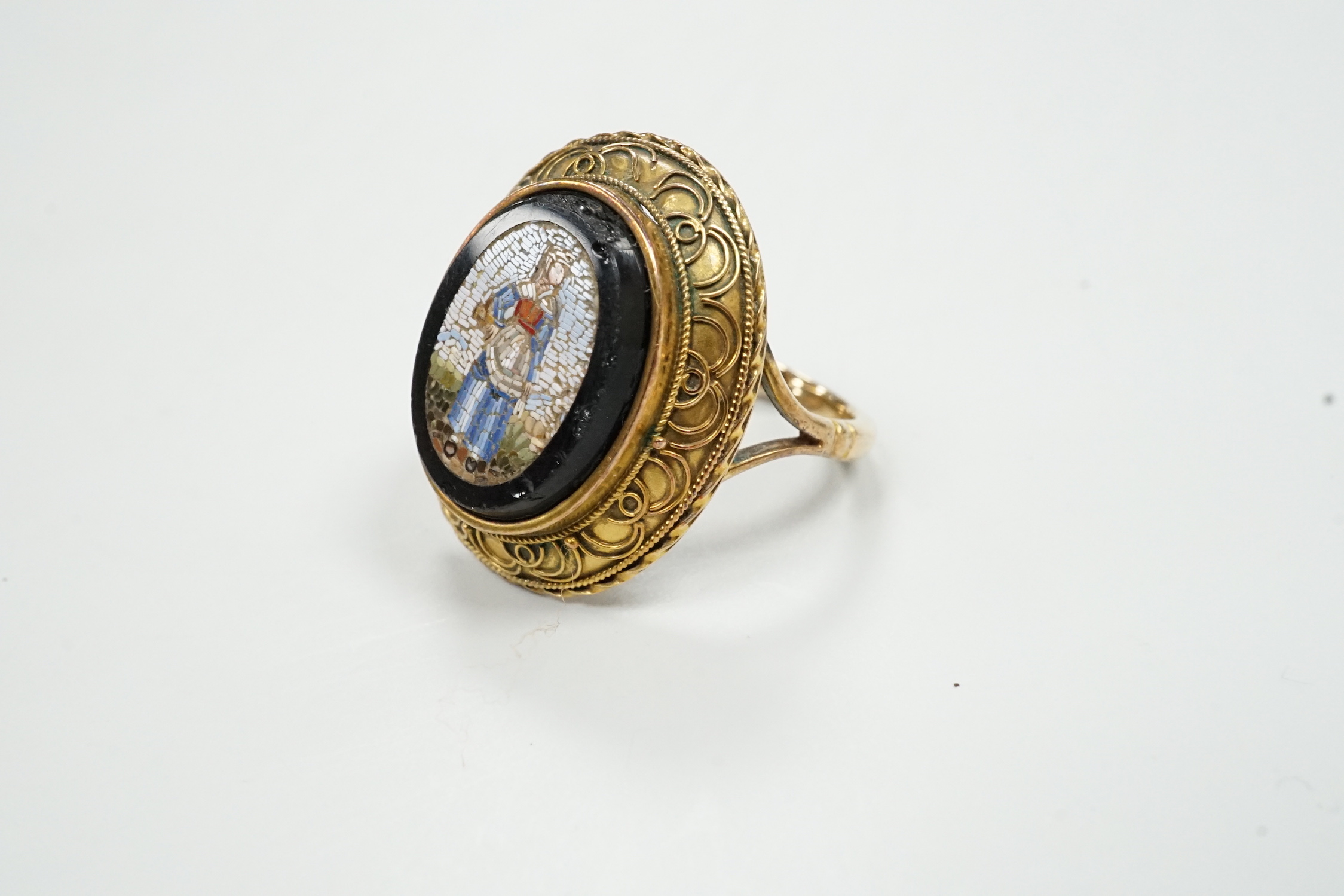 A 19th century yellow metal and micro mosaic set oval ring, size O, gross weight 5.9 grams.